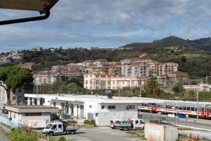 a city with a train and buildings and a train station at Mulino Suites in Scalea