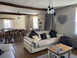 a living room with a couch and a table at The Hideaway Embleton in Embleton