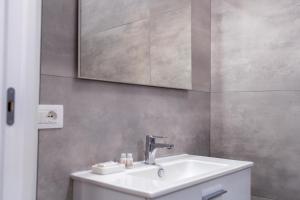 a bathroom with a sink and a mirror at Mulino Suites in Scalea