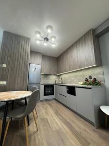 a kitchen with a table and a table and chairs at Parkr Land Elite in Uzhhorod
