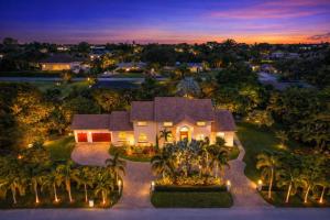 an aerial view of a house with palm trees and lights at Sawgrass Estates in Plantation