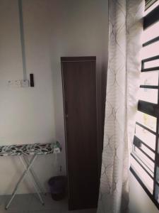a door in the corner of a room with a window at HAIZRINA HOMESTAy in Sungai Petani