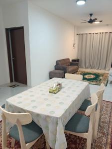 a dining room table and chairs in a living room at HAIZRINA HOMESTAy in Sungai Petani