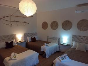 a hotel room with two beds and a chandelier at Casa Rural MONTE VERDE in Illana +46 photos
