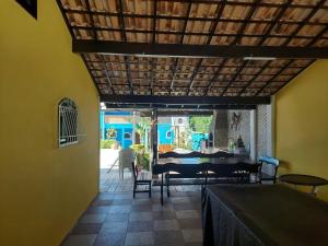 a dining room with a table and a table and chairs at Pousada Summer Beach by Itaúna in Saquarema
