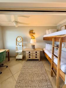 a bedroom with two bunk beds and a table at Deja Blue in Westbrook +16 photos