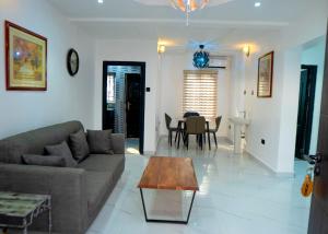 a living room with a couch and a table at Riverside Nest Owerri LTD in Owerri