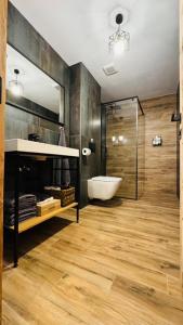 a bathroom with a tub and a sink and a mirror at Apartmany FABRIK in Vysoká nad Kysucou +41 photos