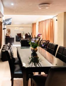 a living room with a table and chairs at Hotel & Suites Domani in Progreso