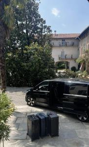 a black limousine parked next to three pieces of luggage at Guided city Tour package in Tangier