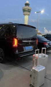 a black car parked in a parking lot with a suitcase at Guided city Tour package in Tangier