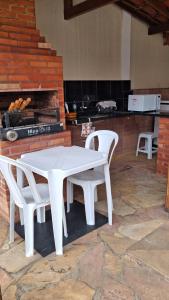 a white table and two white chairs on a patio at Santos & Oliveira in Diamantina
