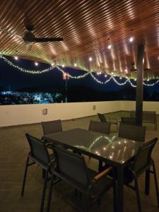 a dining room with a table and chairs and lights at Departamento Huatulco 1 Torre Bel in Santa Cruz Huatulco