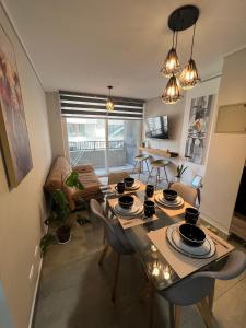 a living room with a dining room table and chairs at Live Epicentro in Temuco +32 photos