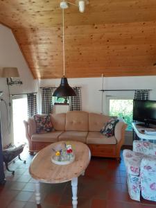 a living room with a couch and a coffee table at Boerderij de Breken in Heerde