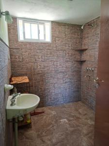 a bathroom with a sink and a shower at Cabaña Terracota in Maimará +1 photo