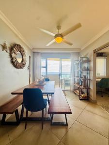 a dining room with a table and a ceiling fan at Deja Blue in Westbrook