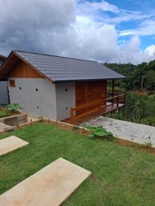 a house with a large yard in front of it at Chales Vista da Mata 01 in Santa Teresa