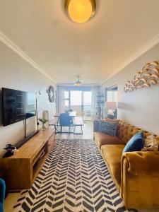 a living room with a couch and a flat screen tv at Deja Blue in Westbrook