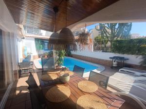a patio with a table and chairs and a pool at Beautiful Holiday Villa with heated private pool, Los Cristianos in Los Cristianos