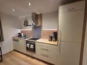 a kitchen with a stove and a refrigerator at Tante Maridi in Forstau