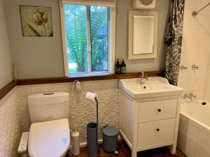 a bathroom with a toilet and a sink and a window at Allview Escape Blackheath in Blackheath +47 photos