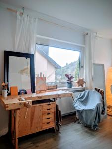 a desk with a mirror and a window in a room at Basislager Rheinsteig in Bad Hönningen +19 photos