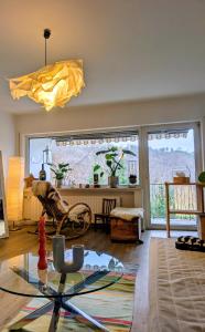 a living room with a glass table and a large window at Basislager Rheinsteig in Bad Hönningen