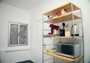 a shelf with a microwave on it next to a window at Appartement Moderne Centre ville BZV in Brazzaville
