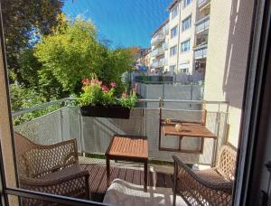 a balcony with a table and two chairs and a table at Ferienwohnung Central in Rostock