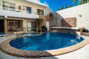 a swimming pool in the middle of a house at Hotel & Suites Domani in Progreso