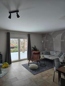 a living room with a couch and a table at Ferienhaus Fliederhain in Stollberg