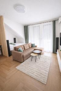 a living room with a couch and a table at Lana Apartmani Autor in Tuzla