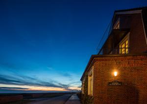 a building with a light on the side of it at Haus Nordland in Juist +10 photos
