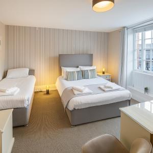 a bedroom with two beds and a window at The Hand Hotel in Chirk