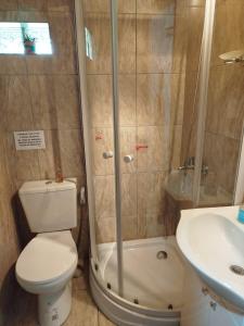 a bathroom with a shower and a toilet and a sink at Ohana in Potrero de Garay +11 photos