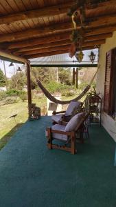 a group of lounge chairs under a covered porch at Ohana in Potrero de Garay