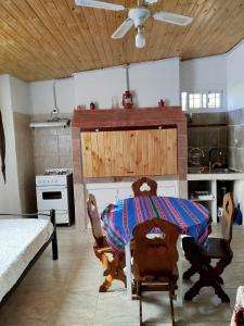 a kitchen with a table and chairs in a room at Ohana in Potrero de Garay