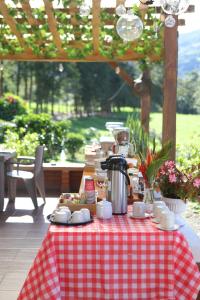 a table with a red and white checkered table cloth at Finca La Playa Ecohotel - Experiencia Campestre - in Salento