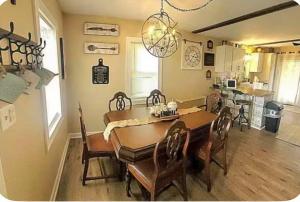 a dining room with a wooden table and chairs at The Hideaway in North Canton +9 photos