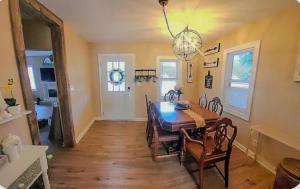 a dining room with a table and chairs and a chandelier at The Hideaway in North Canton
