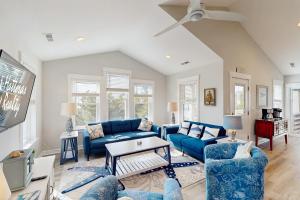 a living room with blue couches and a tv at AV723 Prickly Pear 723 in Avon