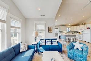 a living room with blue couches and a kitchen at AV723 Prickly Pear 723 in Avon