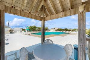 a patio with a table and chairs and a pool at AV723 Prickly Pear 723 in Avon