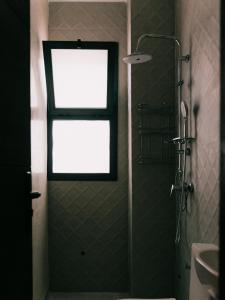 a bathroom with a shower with a window and a sink at Mish Mish in Tamraght Ouzdar +43 photos