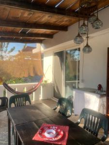 a dining room with a wooden table and chairs at Casa del Alma in Puerto Escondido