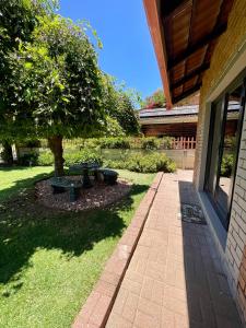 a patio with a tree next to a building at Peach Blossom Guesthouse in Welkom