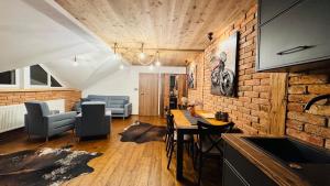 a kitchen and living room with a brick wall at Apartmany FABRIK in Vysoká nad Kysucou