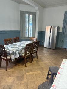 a kitchen with a table and chairs and a refrigerator at Familyhostel in Santiago +13 photos