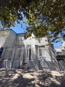 a white building with gates in front of it at Familyhostel in Santiago